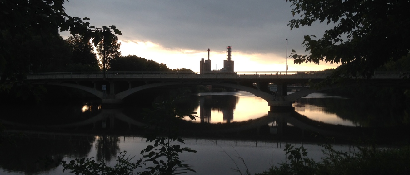 Evening photo of a river with a bridge